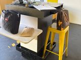 a desk with a laptop and a bag on top of it