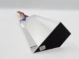 a silver and black object on a white surface