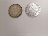 two coins that are on a table with a price tag