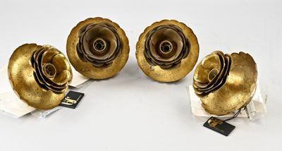three gold roses are sitting on top of a piece of paper