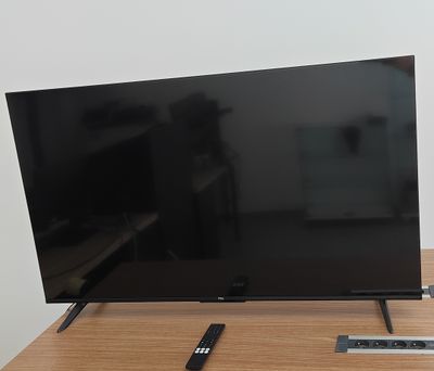 a flat screen tv sitting on top of a wooden table