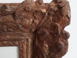 a close up of a wooden frame with carvings on it