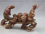 a figurine of a man and a woman with pots on a table