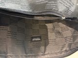 a black bag with a zipper on it sitting on a table