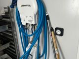 a blue hose attached to a white wall next to a baseball bat