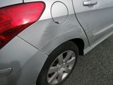 a silver car that is parked on the side of the road