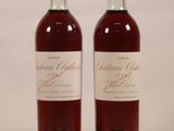 two bottles of wine sitting next to each other on a table