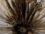 a clock with a bunch of dried flowers on it