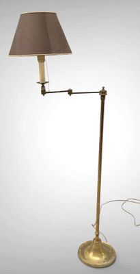 brass floor lamp with a brown shade on a white background