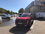 a red car parked in front of a building in a parking lot
