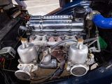 a small engine in the back of a blue car