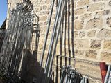 a lot of metal poles leaning against a stone wall