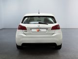 the rear end of a white car in a white room