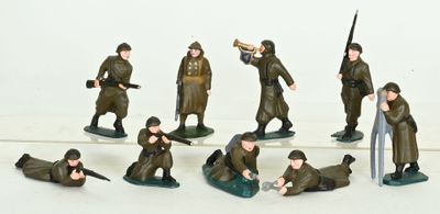 a lot of figurines of soldiers on a white surface