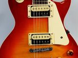 a close up of a red electric guitar with a white fret