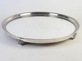 a silver tray with a handle on a white surface