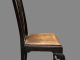 an image of a chair with a leather seat on a gray background