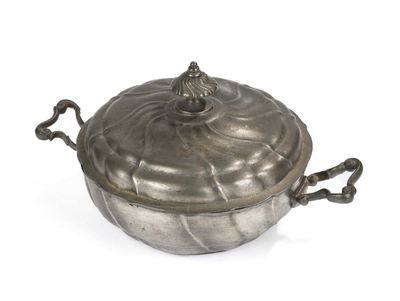 an antique silver plated casserole with handles on a white background