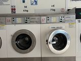 a row of washing machines in a public washroom