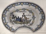 a blue and white plate with a picture of a man on it
