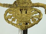 a close up of a sword with a gold decoration on it
