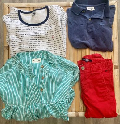 three pairs of shorts and a t - shirt are laid out on a bamboo mat