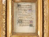 an ornate gold frame with a picture of a man and a woman