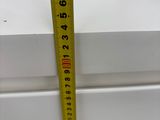 a measuring tape on the edge of a window sill