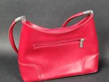 a red purse with a zipper on the front and a silver handle
