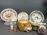 many different types of pottery on display on the table