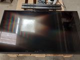 a flat screen tv sitting on a pallet on the floor