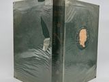 a green book with a picture of a woman on it
