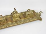an antique brass inkwell with three inkwells on top of it