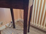 a wooden table with a suitcase on top of it