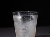 a glass with ice in it on a table