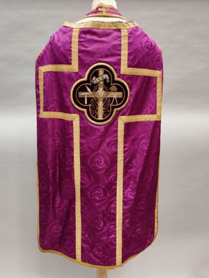 a close up of a purple and gold vest with a cross on it