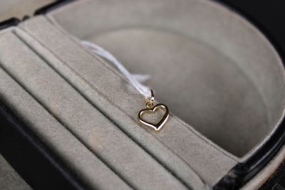 a piece of luggage that has a gold heart charm in it