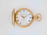 an old gold pocket watch with roman numerals and roman numerals on the face