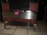 a stainless steel sink with a pink sign on it