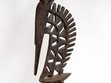 an image of a wooden sculpture of a bird on a stand