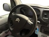 dashboard view of a car with a steering wheel and dashboard controls