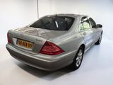 a silver car that is parked in a white room