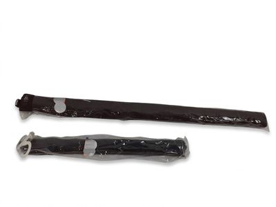 two knives that are wrapped in plastic on a white surface