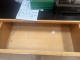 a drawer that has a book on top of it