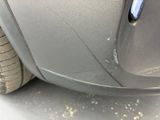 a close up of a car ' s front bumper and tire
