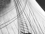 black and white photograph of a man standing on a sail