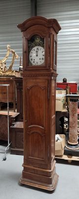 a grandfather clock sitting in the middle of a room