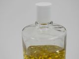 a bottle of liquid with a yellow substance inside of it