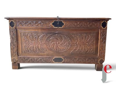 an image of a wooden chest with carvings on the sides