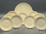 a set of six white dinner plates with dots on them